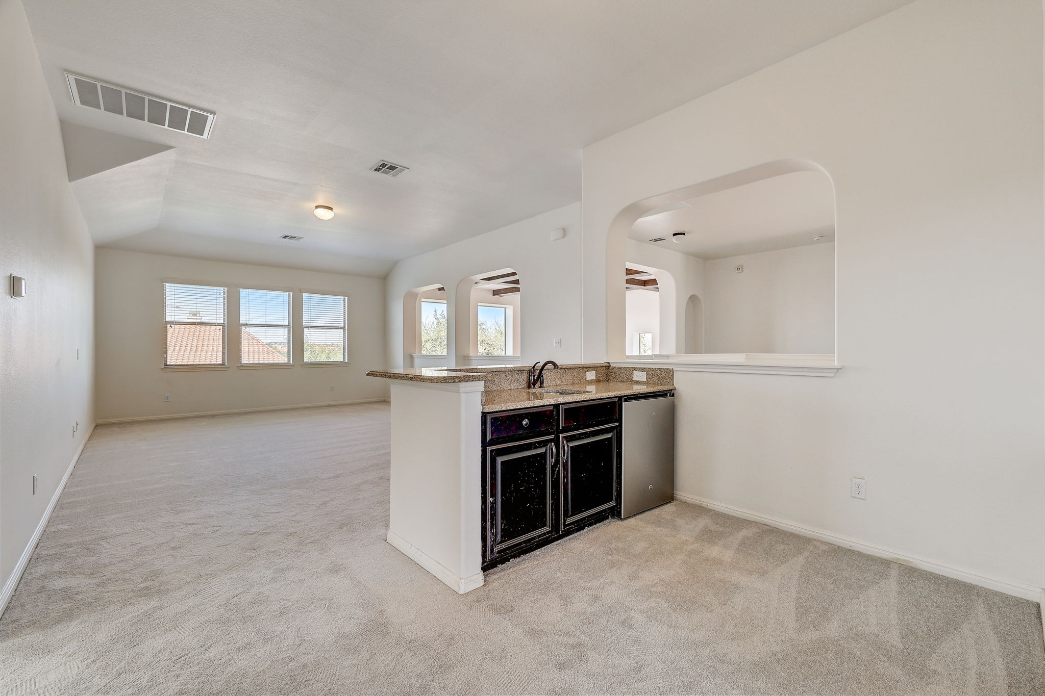 16012 Spillman Ranch Loop Austin, TX 78738 - Photo 23 of 38 An inviting open-concept layout features a well-appointed wet bar, perfect for entertaining.
