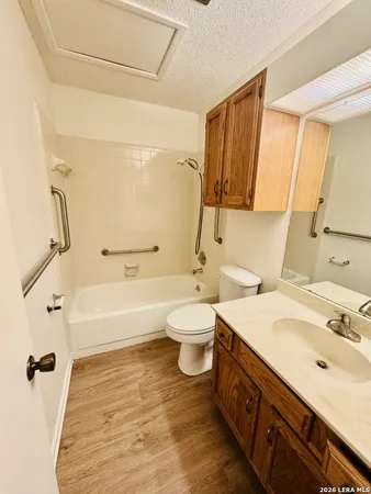 a bathroom with a double vanity sink toilet mirror and bathtub