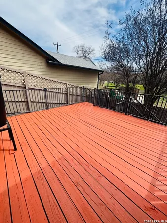 a balcony view with wooden floor and fence