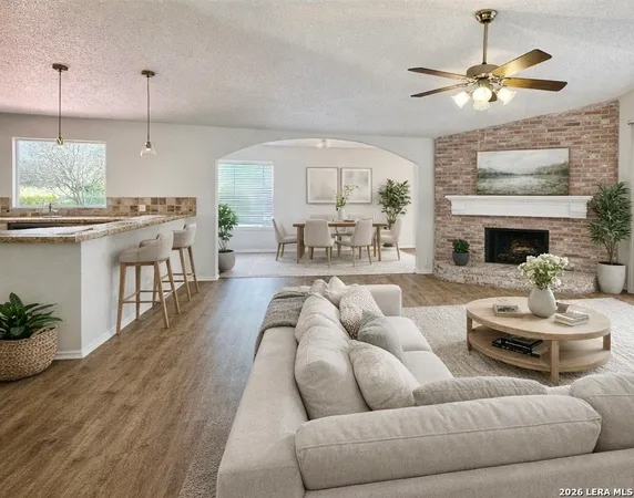 a living room with furniture a fireplace and a chandelier