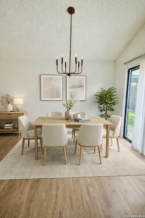 a view of a dining room with furniture and wooden floor