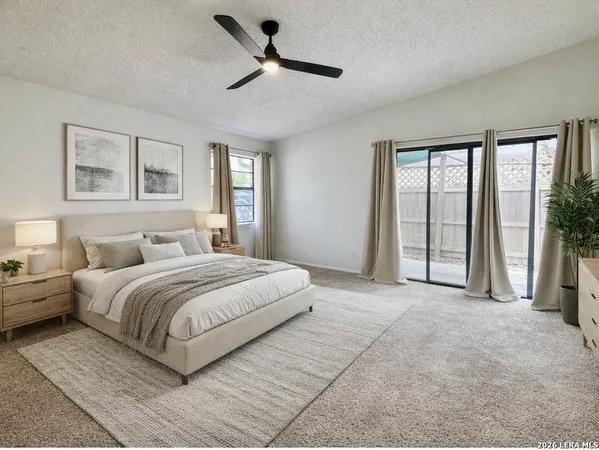 a spacious bedroom with a large bed and a large window