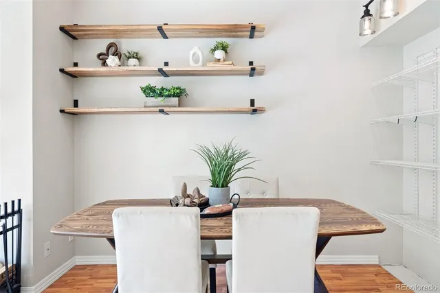 a white table sitting in a kitchen next to a shelf