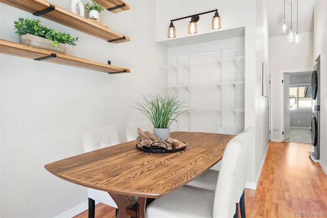 a view of a dining room with a table and chairs