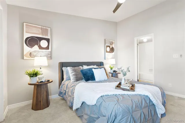 a bedroom with bed and flowerpot