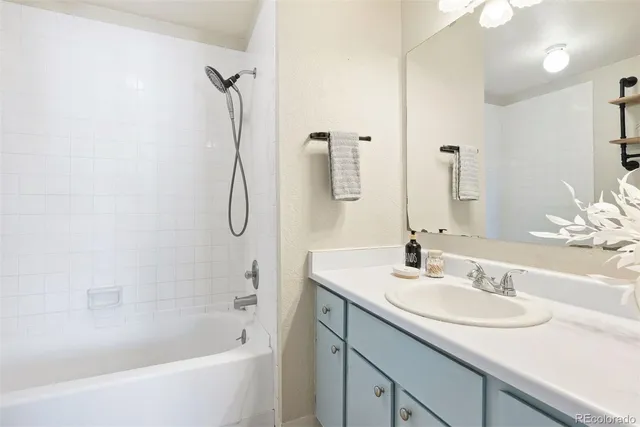 a bathroom with a bath tub sink and mirror
