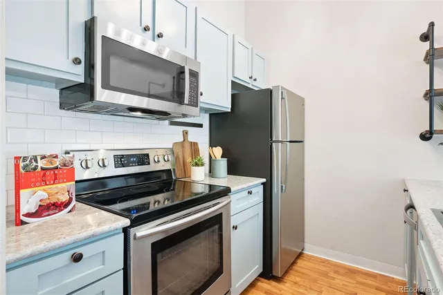a kitchen with a stove microwave and refrigerator