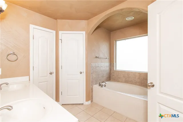 a bathroom with a bathtub and a sink