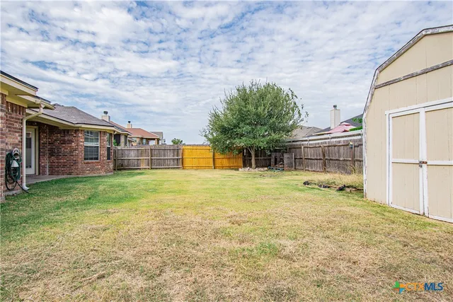 a view of a house with a backyard
