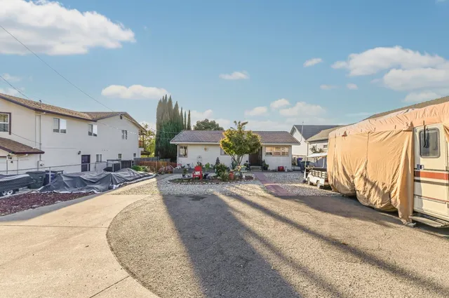 a living room with furniture a floor to ceiling window and a flat screen tv