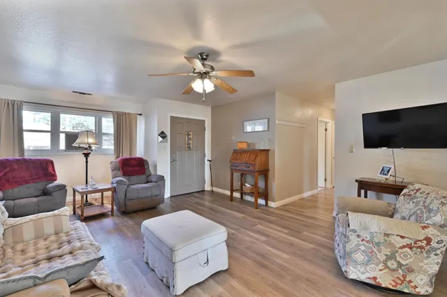 a view of a dining room with furniture and chandelier