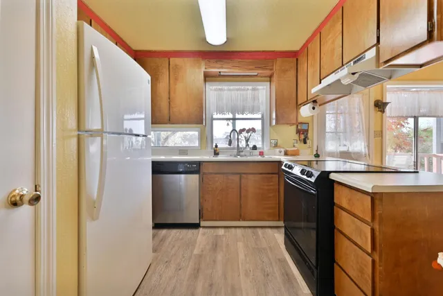 a spacious bathroom with a granite countertop sink a mirror and a toilet
