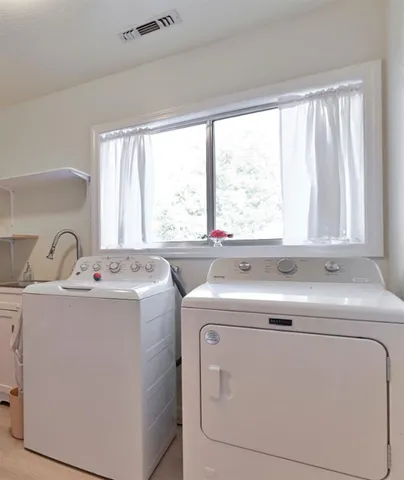a backyard of a house with outdoor seating and trees