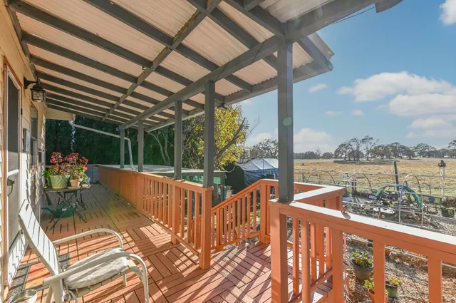 a view of a house with a small yard and wooden fence