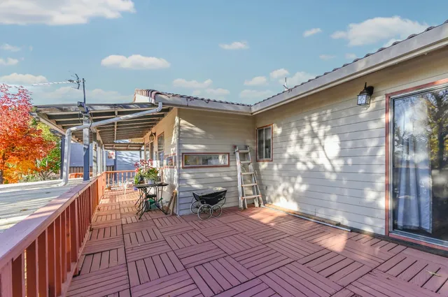 a living room with furniture and a ceiling fan