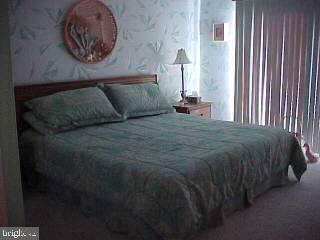 0 Edward Taylor Road, Unit 60 Ocean City, MD 21842 - Photo 4 of 4 a bedroom with a bed and a lamp on table