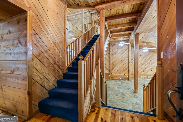a kitchen with granite countertop wooden cabinets stainless steel appliances and a window