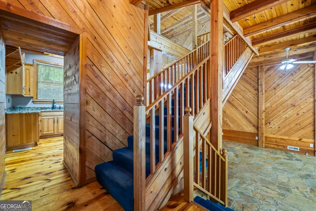 a view of a livingroom with a chandelier furniture and wooden floor