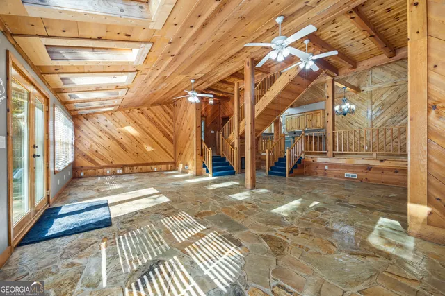 a bathroom with a granite countertop toilet sink and mirror