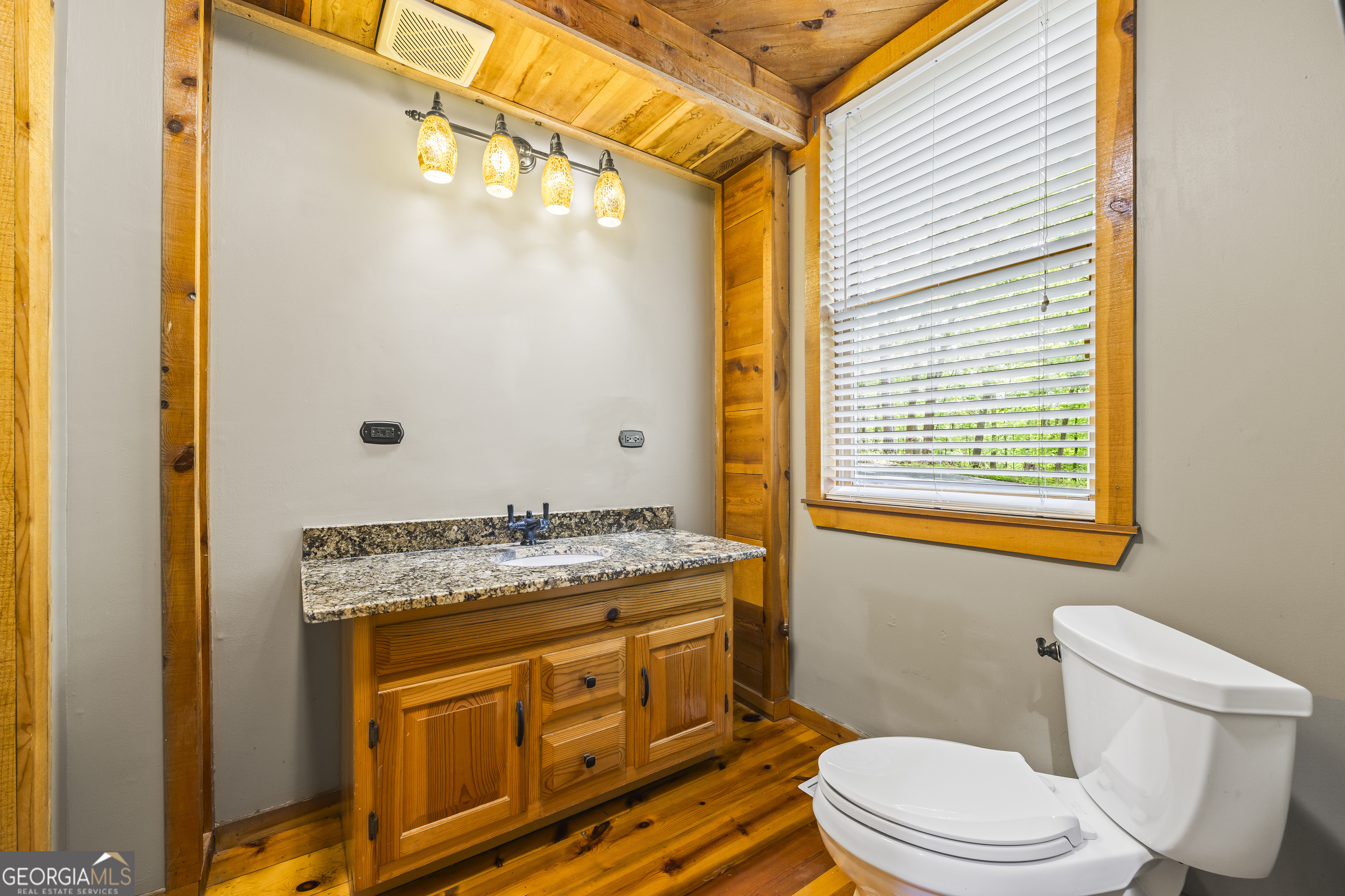 339 Ben Loudermilk Road Mount Airy, GA 30563 - Photo 27 of 49 a bathroom with a granite countertop toilet sink and mirror