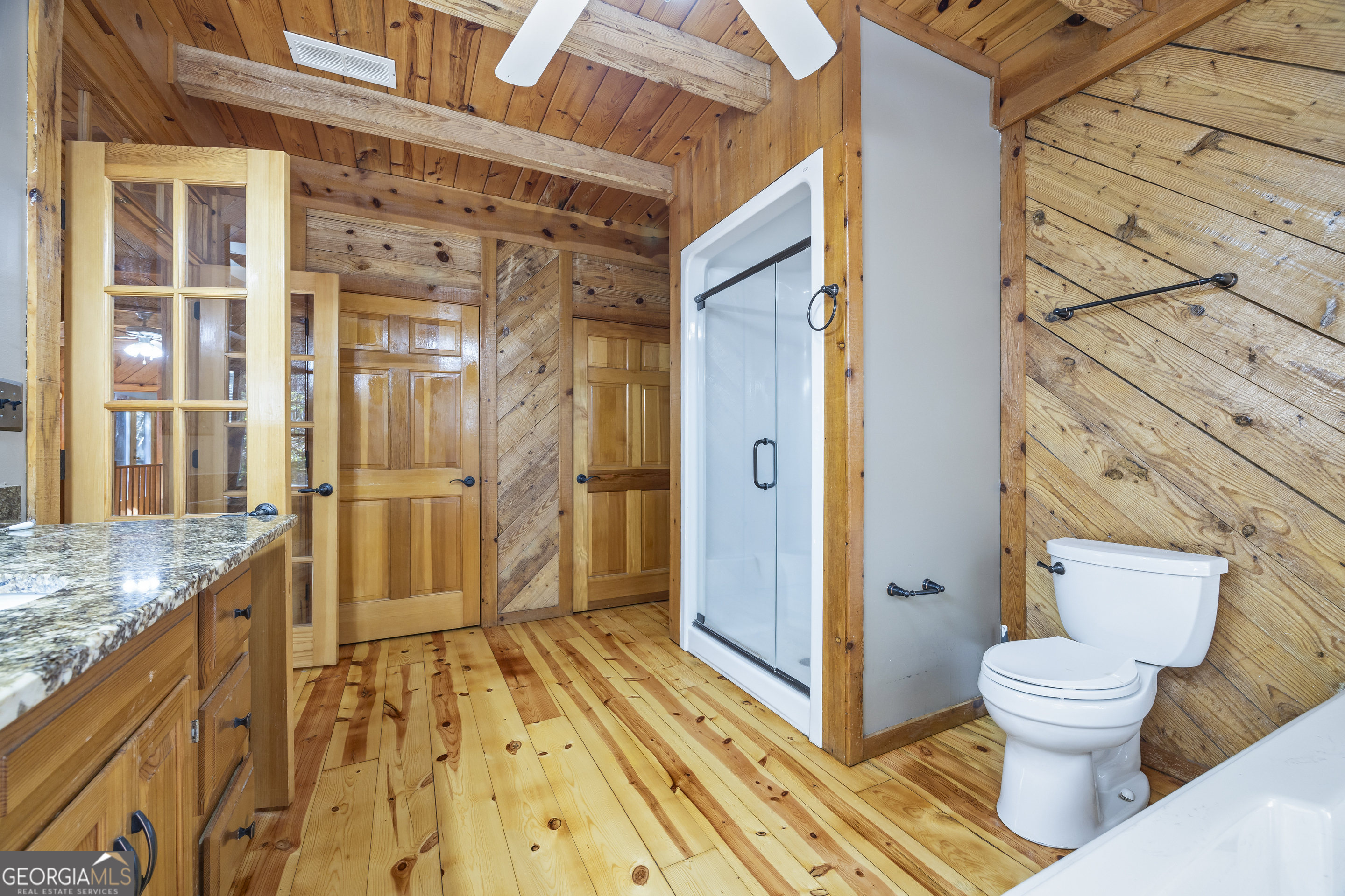 339 Ben Loudermilk Road Mount Airy, GA 30563 - Photo 39 of 49 a bathroom with a granite countertop shower and a toilet