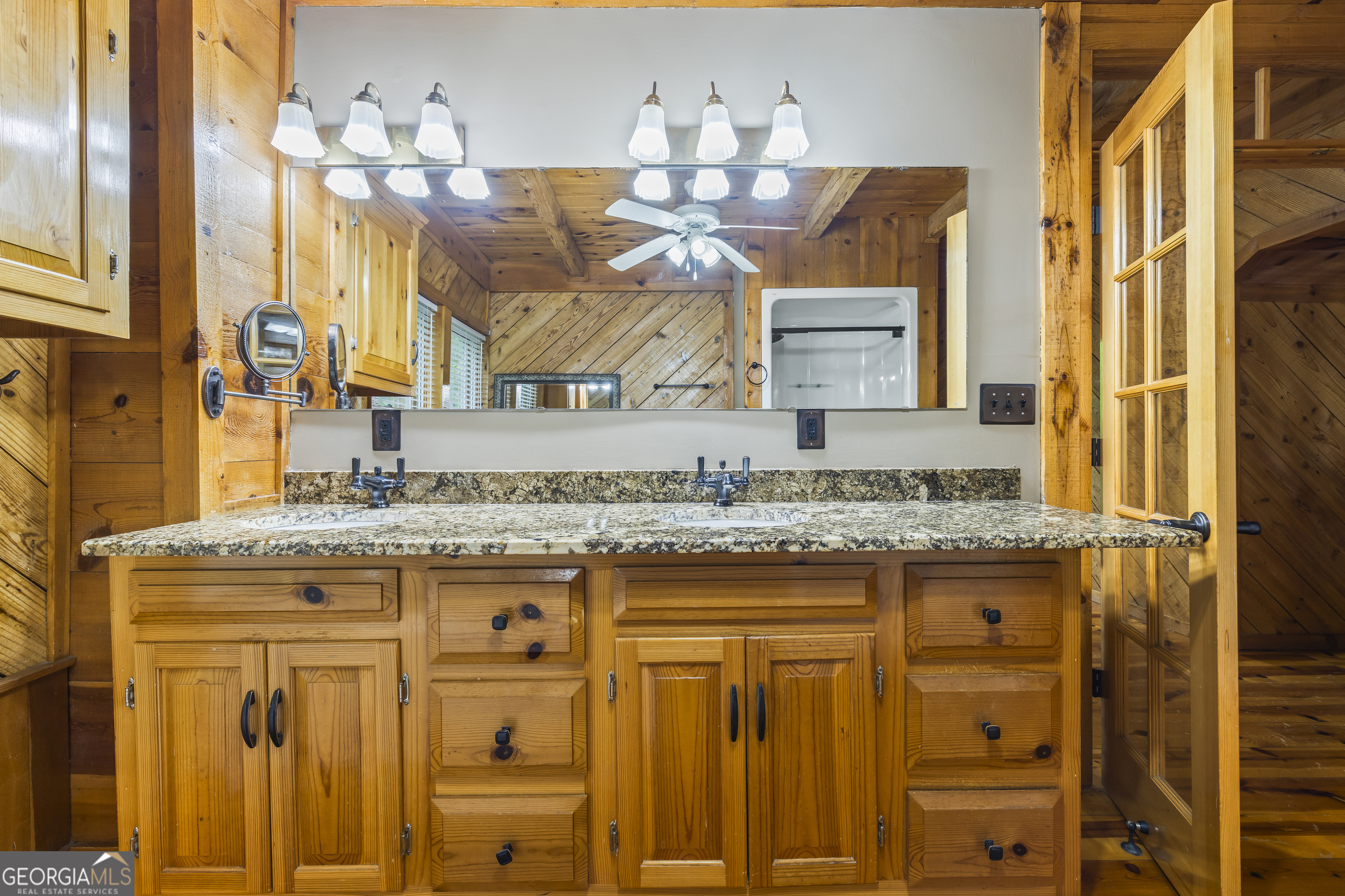 339 Ben Loudermilk Road Mount Airy, GA 30563 - Photo 40 of 49 a bathroom with a granite countertop sink and a mirror