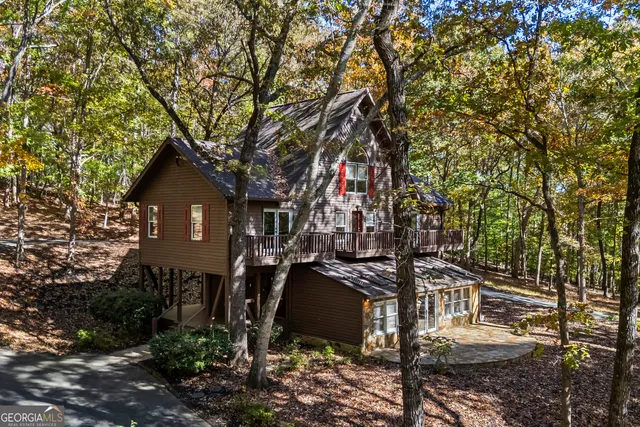 a front view of a house with a tree