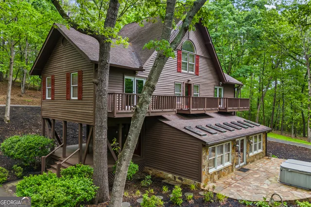a front view of house with a garden