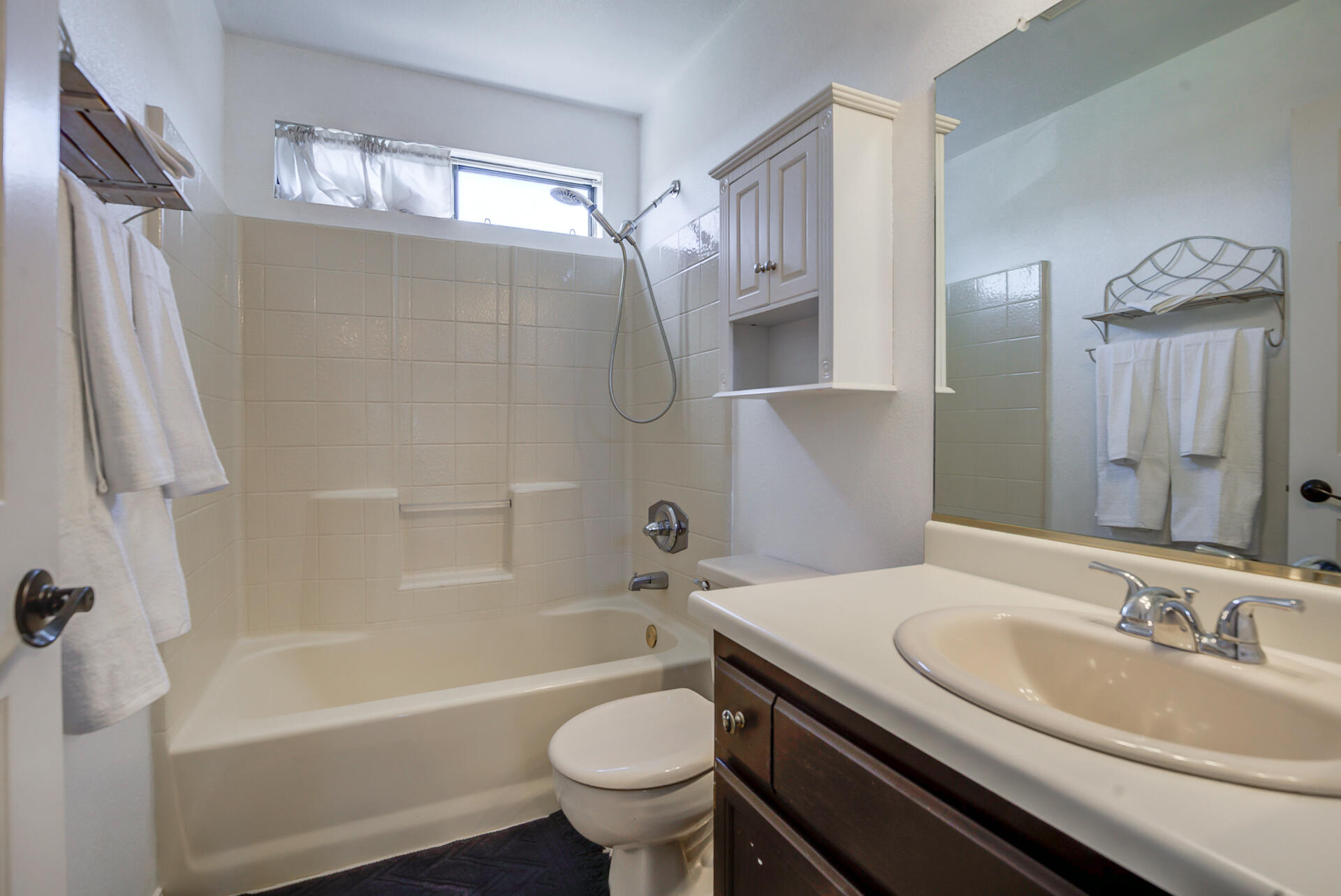 11326 Puffin Way Redding, CA 96003 - Photo 13 of 34 a bathroom with a sink a toilet a mirror a bathtub and shower