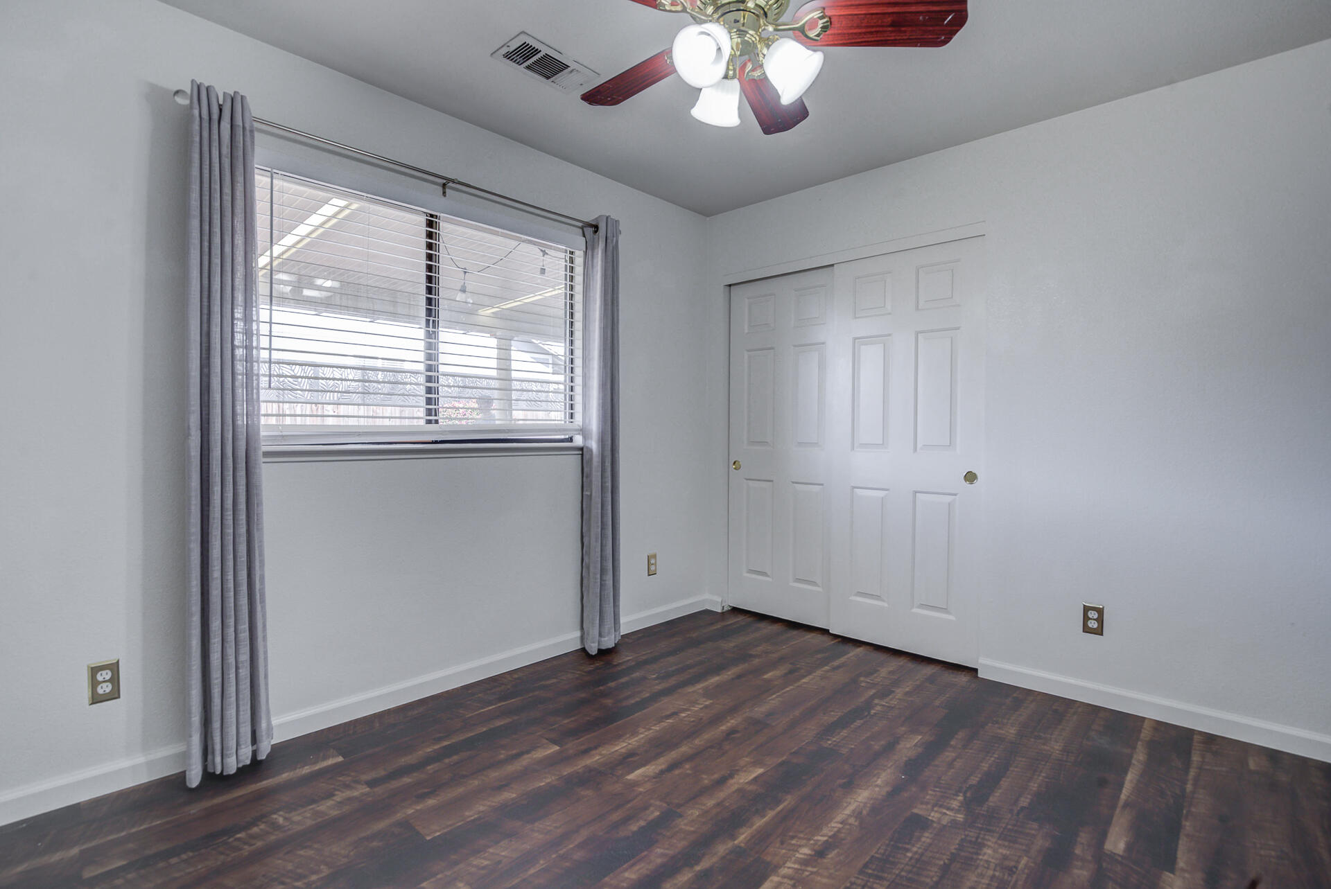 11326 Puffin Way Redding, CA 96003 - Photo 16 of 34 an empty room with wooden floor and windows