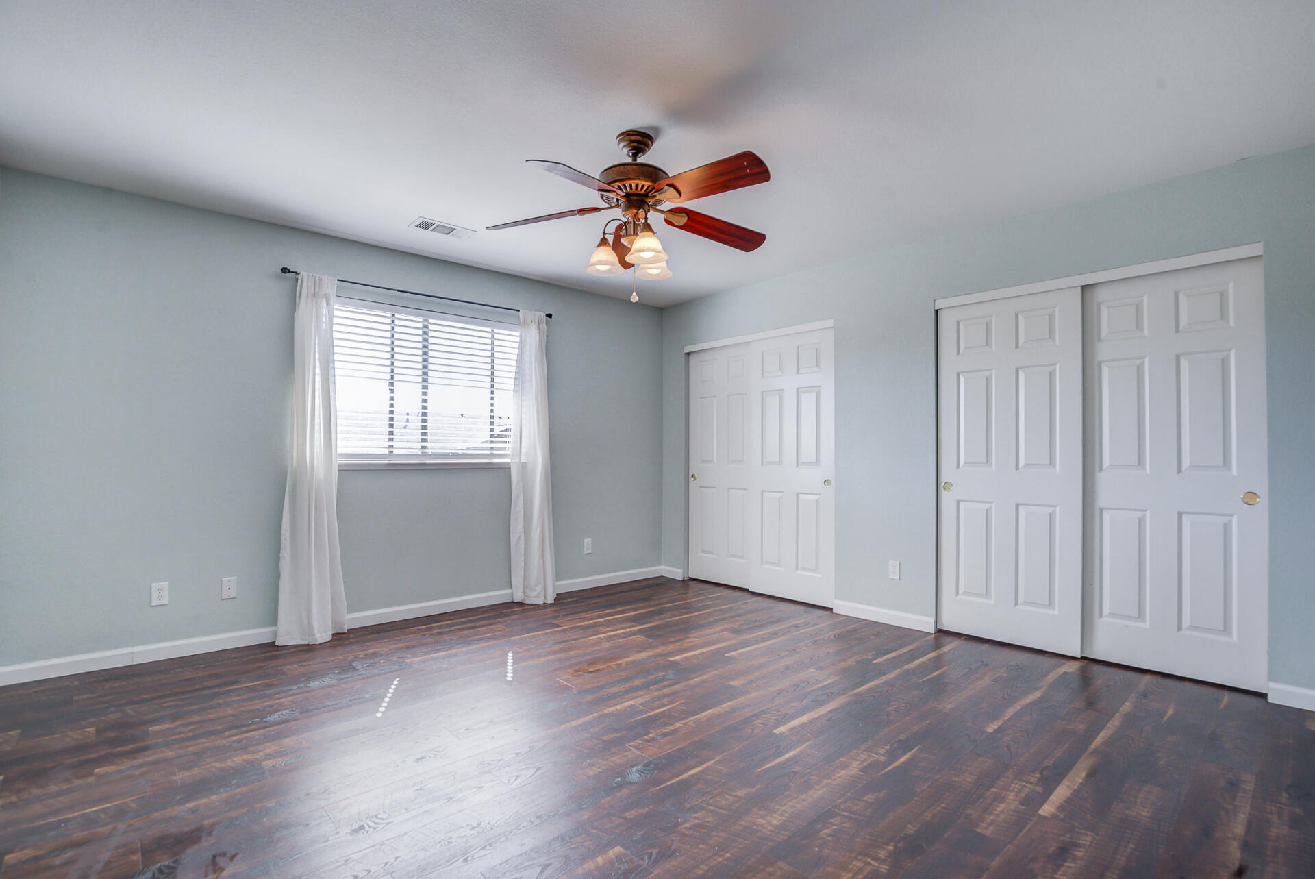 11326 Puffin Way Redding, CA 96003 - Photo 18 of 34 wooden floor in an empty room with a window