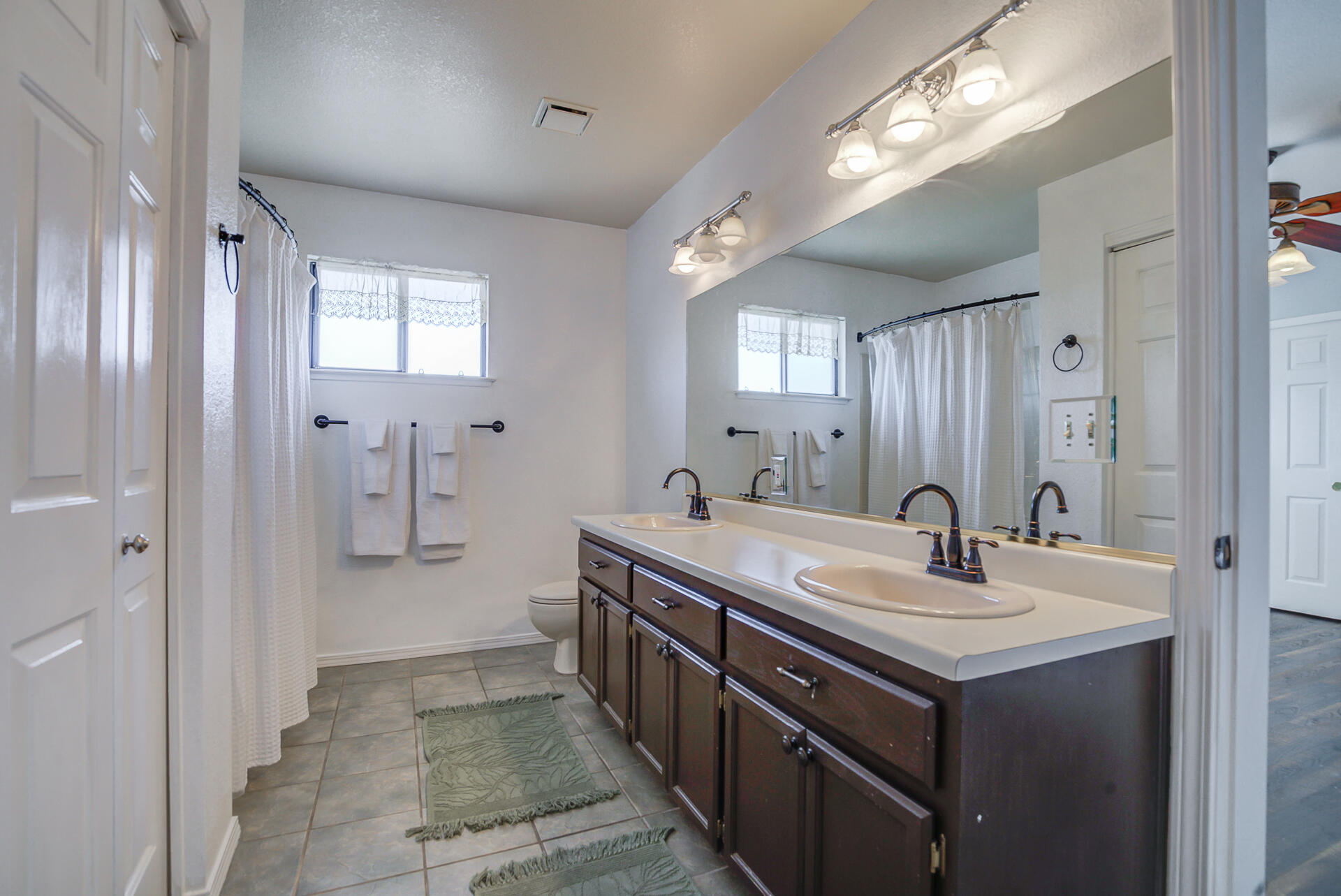 11326 Puffin Way Redding, CA 96003 - Photo 20 of 34 a spacious bathroom with a double vanity sink a mirror and a shower