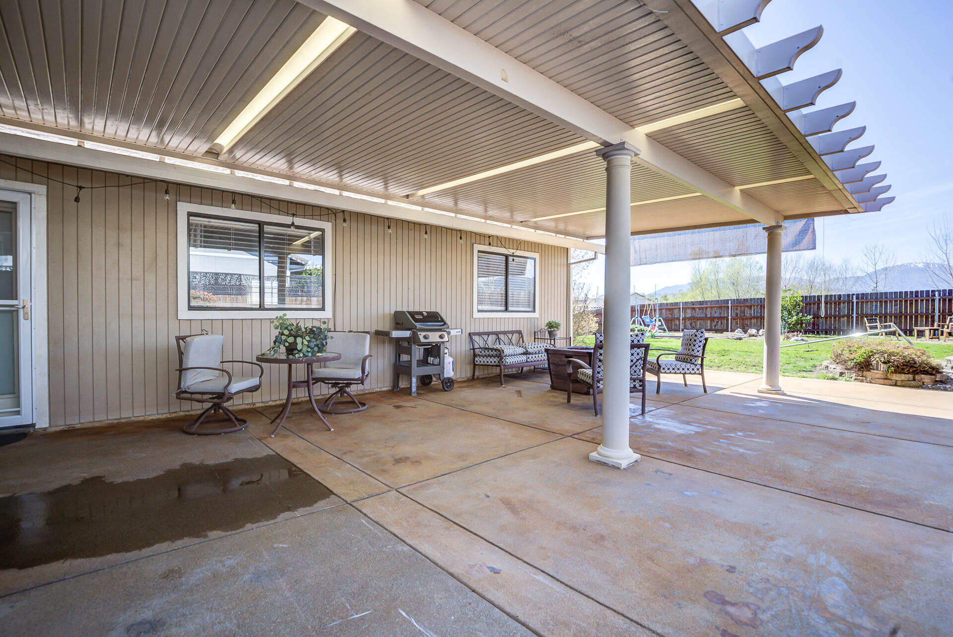 11326 Puffin Way Redding, CA 96003 - Photo 23 of 34 a living room with patio furniture and a yard