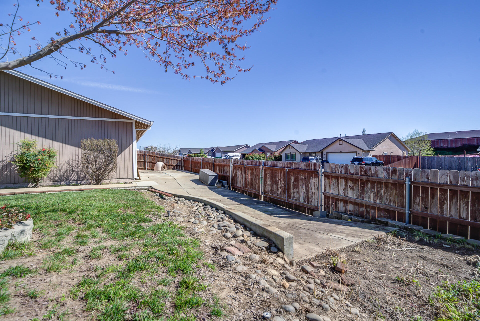 11326 Puffin Way Redding, CA 96003 - Photo 25 of 34 a view of a backyard with wooden fence