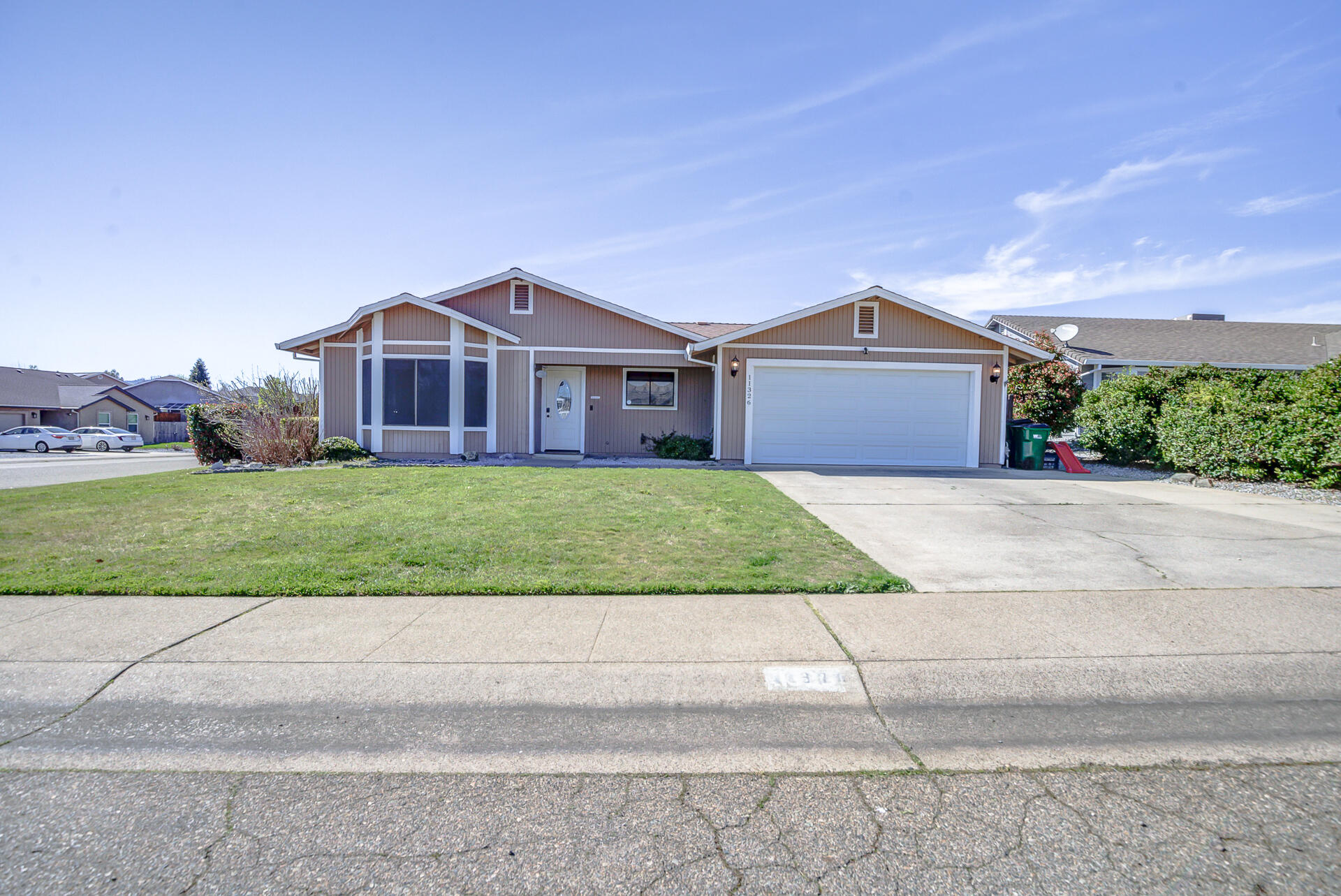 11326 Puffin Way Redding, CA 96003 - Photo 33 of 34 a view of a house with a yard and large tree