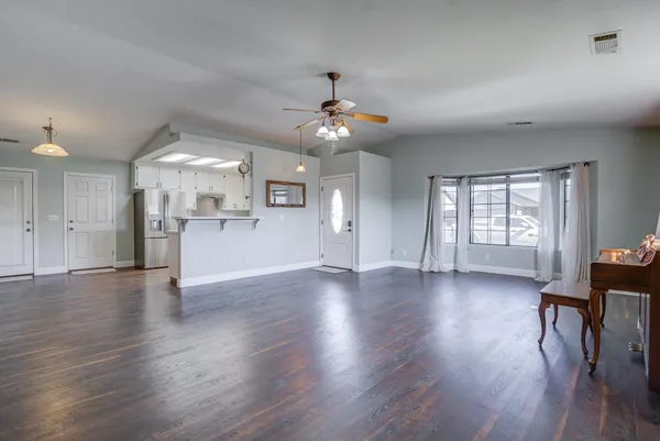 wooden floor in an empty room with a window