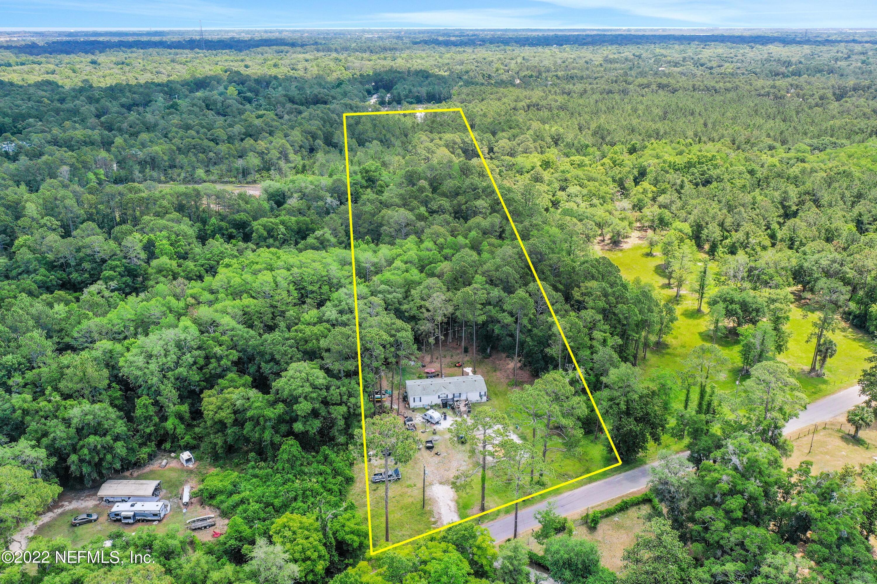 2850 Hilltop Road St. Augustine, FL 32086 - Photo 5 of 11 a view of a forest with a houses