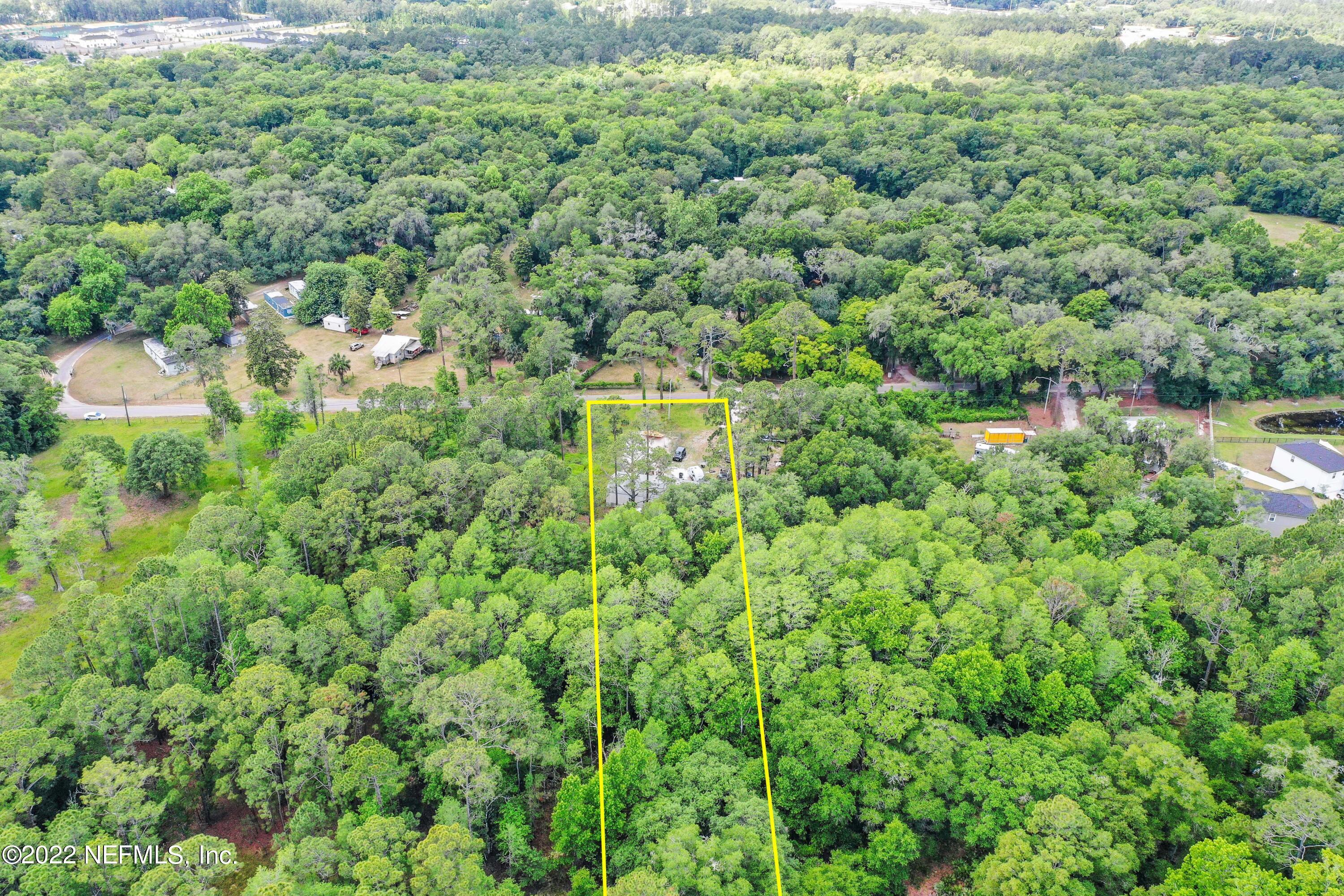 2850 Hilltop Road St. Augustine, FL 32086 - Photo 6 of 11 a view of a forest with a street