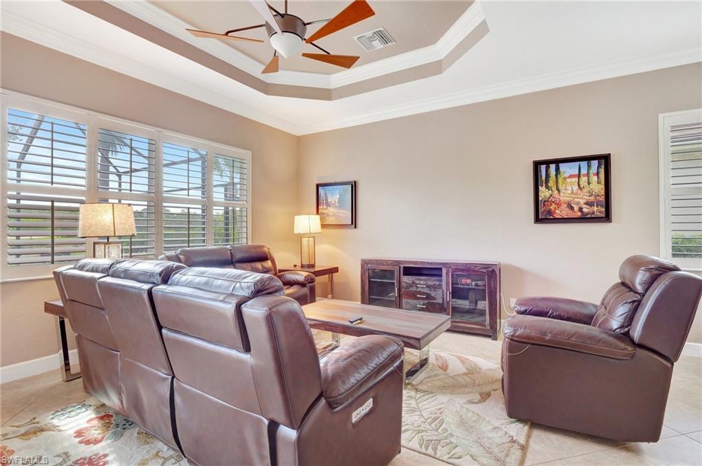 7903 Founders Circle Naples, FL 34104 - Photo 11 of 32 a living room with furniture a flat screen tv and a window