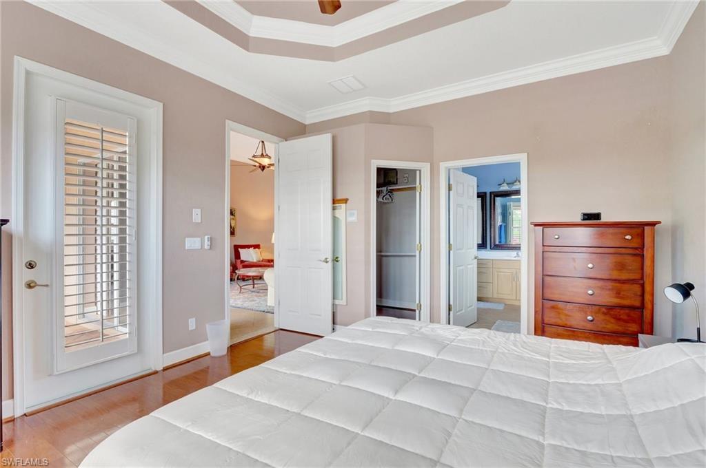 7903 Founders Circle Naples, FL 34104 - Photo 22 of 32 a bedroom with a bed and a cabinets