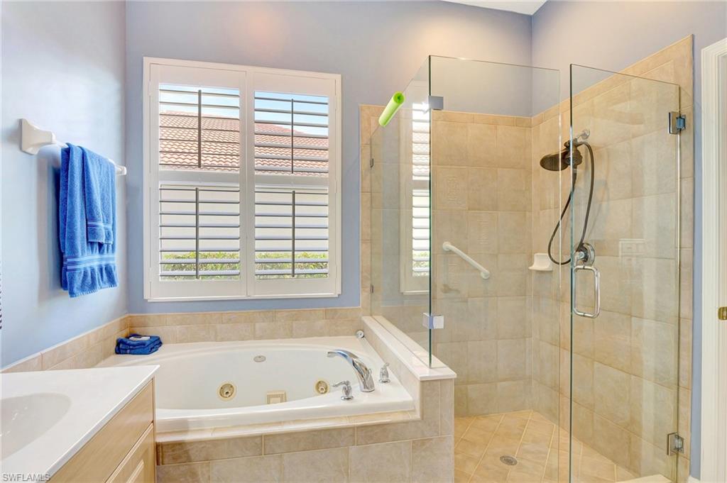 7903 Founders Circle Naples, FL 34104 - Photo 23 of 32 a bathroom with a tub and a shower