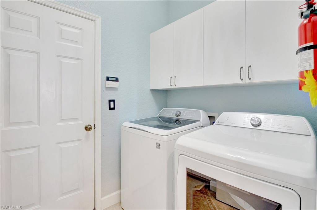 7903 Founders Circle Naples, FL 34104 - Photo 25 of 32 a utility room with dryer and washer