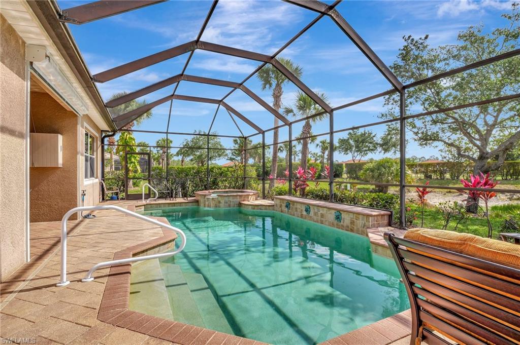 7903 Founders Circle Naples, FL 34104 - Photo 27 of 32 a patio with glass windows and yard