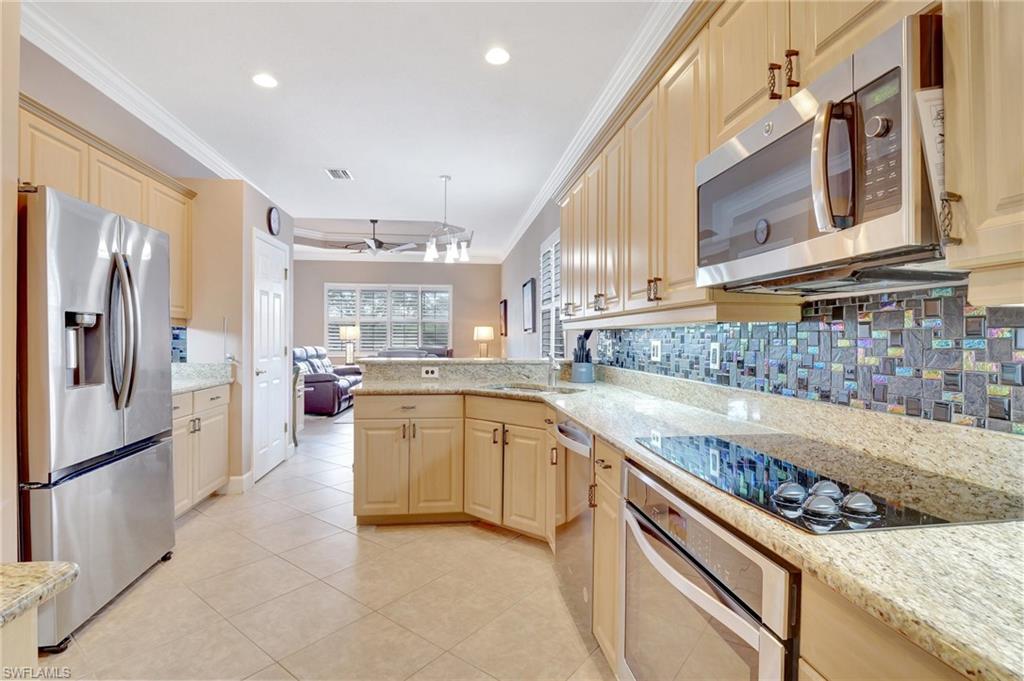 7903 Founders Circle Naples, FL 34104 - Photo 32 of 32 a large kitchen with stainless steel appliances granite countertop a refrigerator and a sink