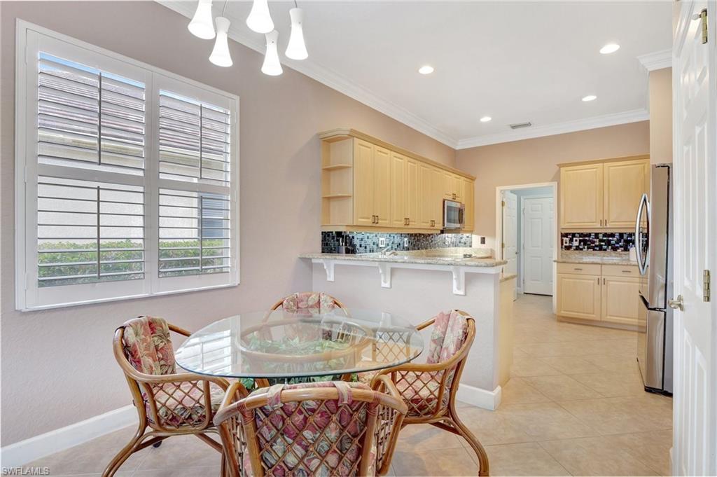 7903 Founders Circle Naples, FL 34104 - Photo 8 of 32 a dining room with furniture and window