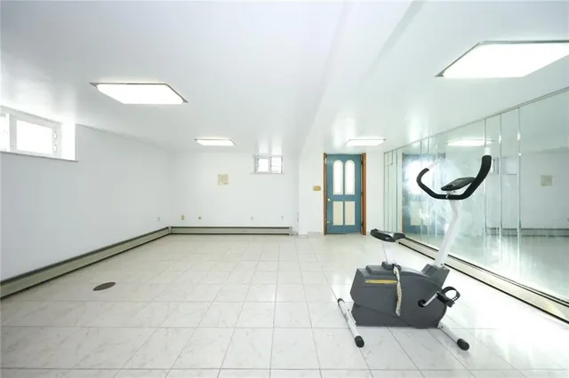 a view of a room with gym equipment and a mirror