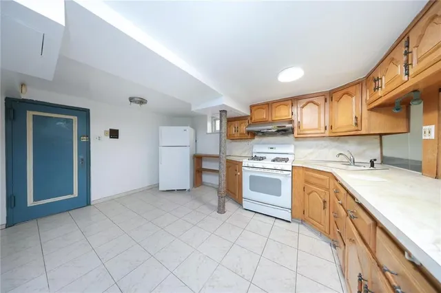 a kitchen with a stove sink and cabinets