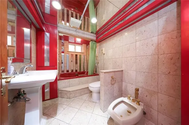 a bathroom with a sink a toilet and a shower