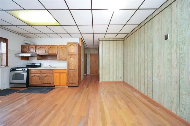 a view of a kitchen with wooden floor and a sink