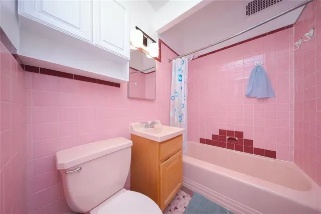 a bathroom with a sink toilet vanity and bathtub